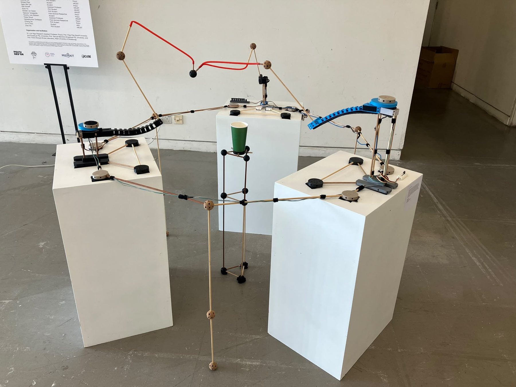 The complete A game that pulls installation shown across four white plinths