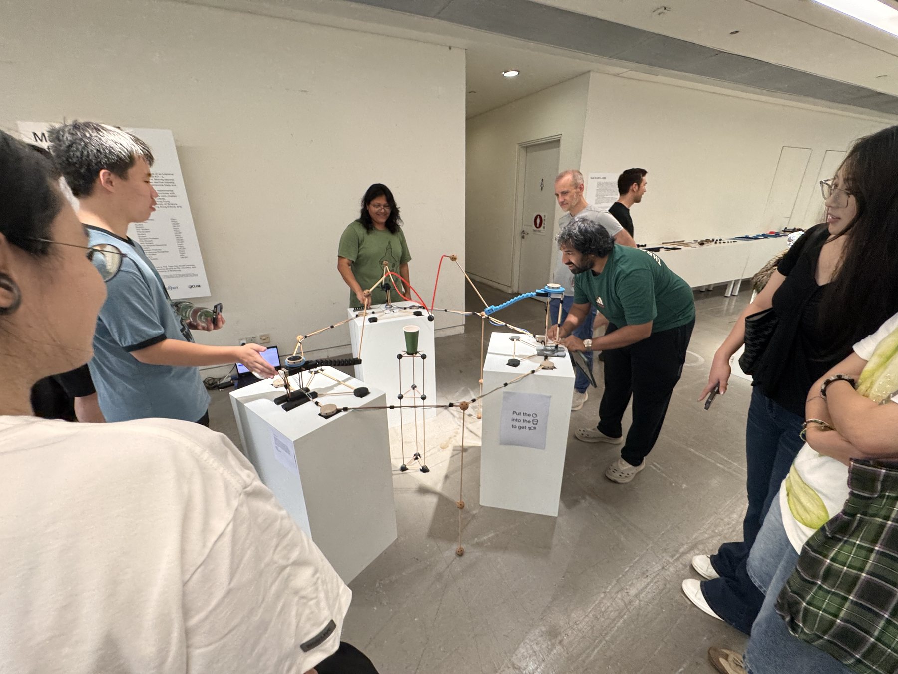 Visitors gathered around and playing A game that pulls during the showcase